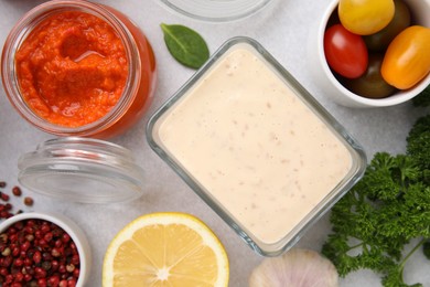 Photo of Different marinades and products on light table, flat lay