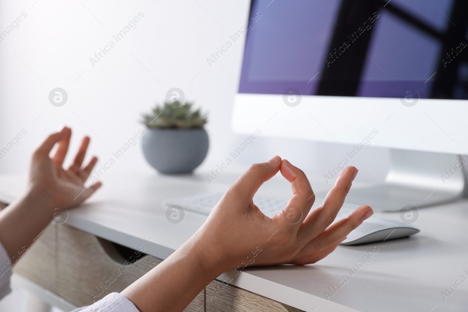 Photo of Find zen. Woman taking break from work at table indoors, closeup