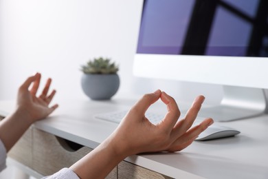 Photo of Find zen. Woman taking break from work at table indoors, closeup