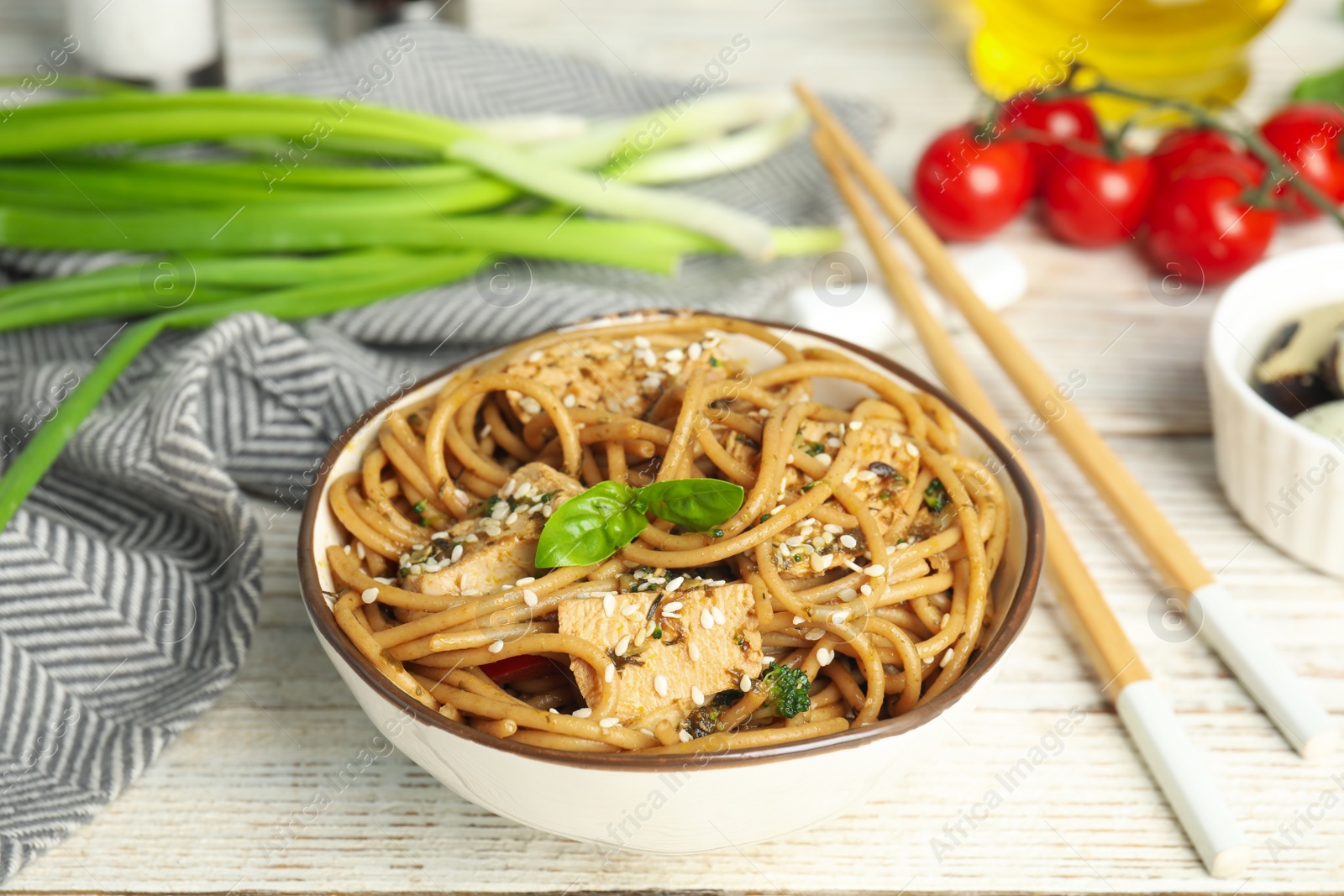 Photo of Tasty buckwheat noodles with meat served on white wooden table