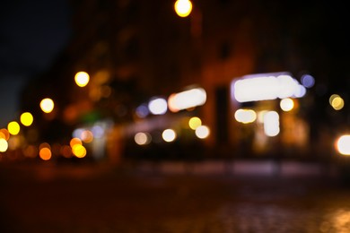 Blurred view of city street with lights at night. Bokeh effect