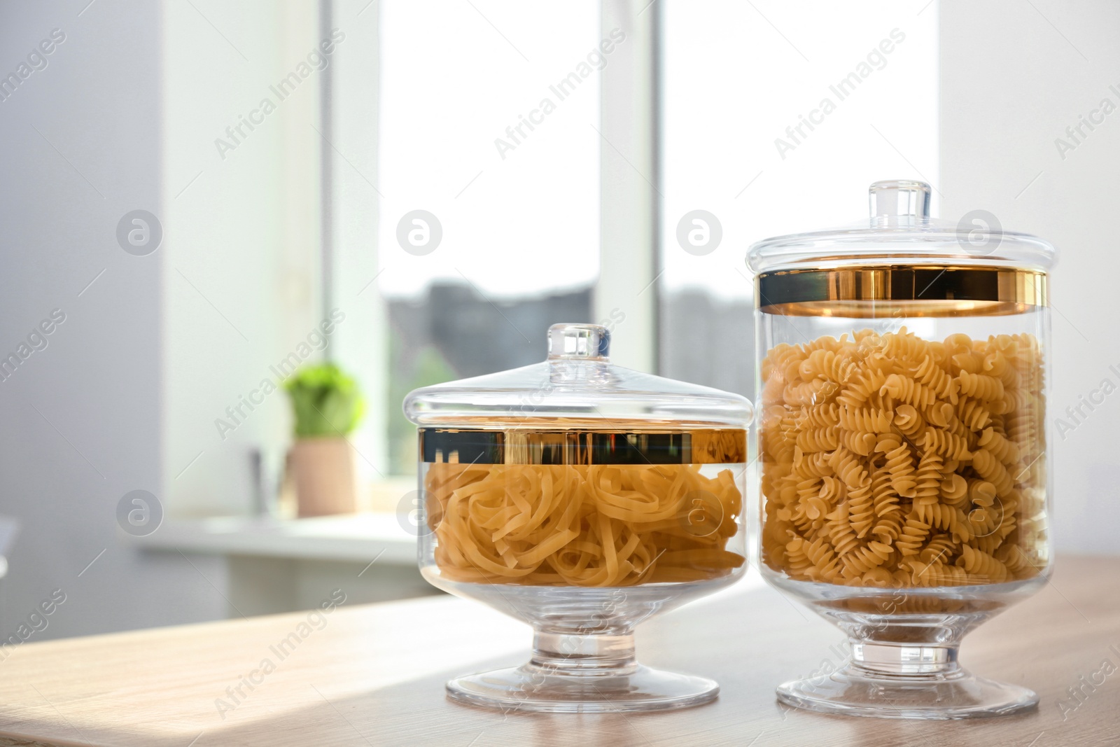 Photo of Products in modern kitchen glass containers on wooden table