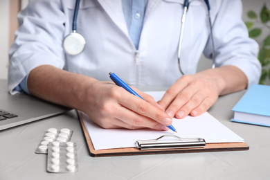 Photo of Doctor working at desk in office, closeup. Medical service