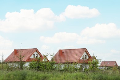 Photo of Modern buildings with red roofs outdoors on spring day