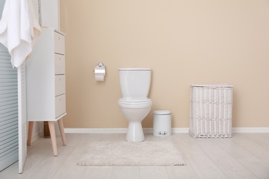 Toilet bowl in modern bathroom interior