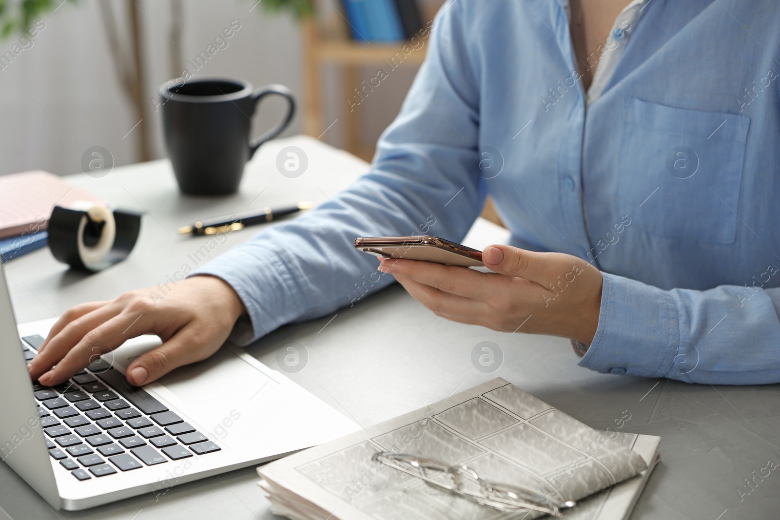 Photo of Journalist with smartphone working at table, closeup