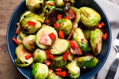 Delicious Brussels sprouts with bacon in bowl, closeup