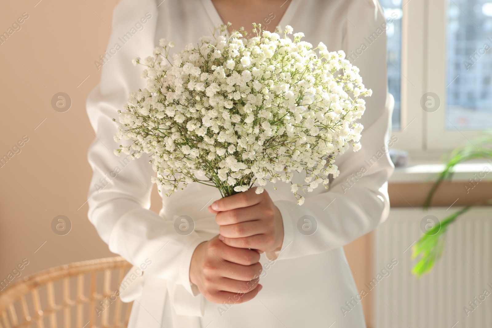 Photo of Bride with beautiful bouquet indoors, closeup view. Wedding day