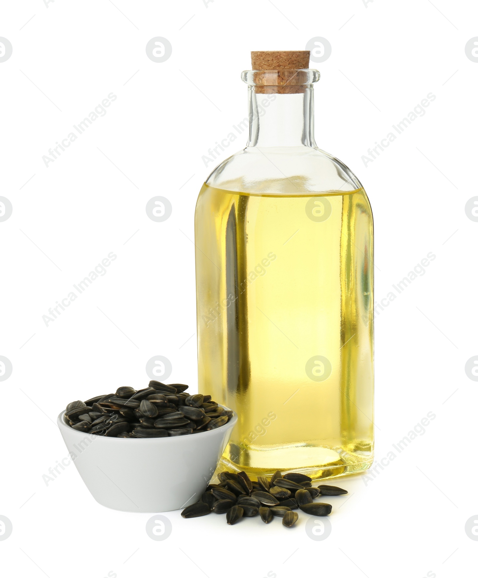 Photo of Vegetable fats. Sunflower oil in glass bottle and seeds isolated on white