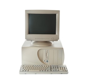 Photo of Old computer monitor, keyboard and system unit on white background