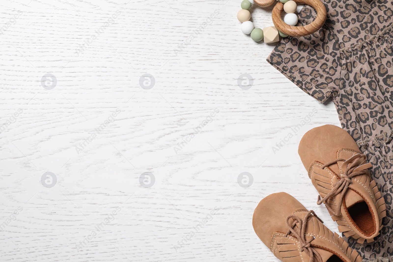 Photo of Stylish baby outfit on white wooden background, flat lay. Space for text