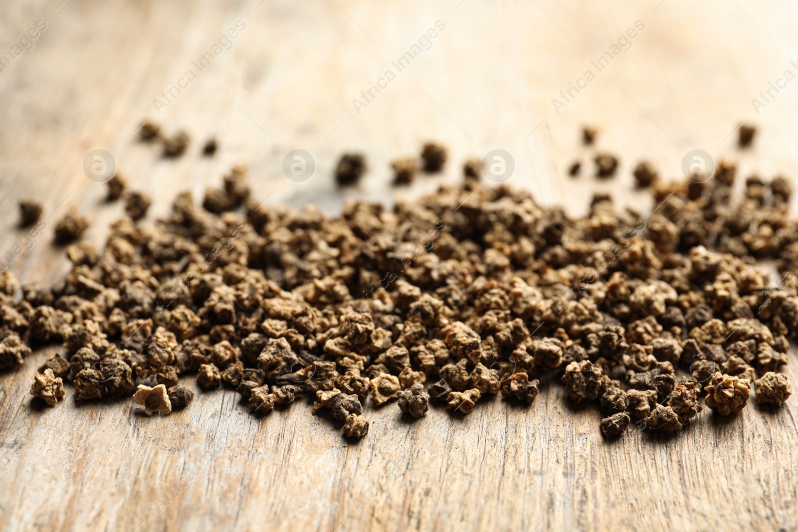 Photo of Raw beet seeds on wooden background, closeup. Vegetable planting