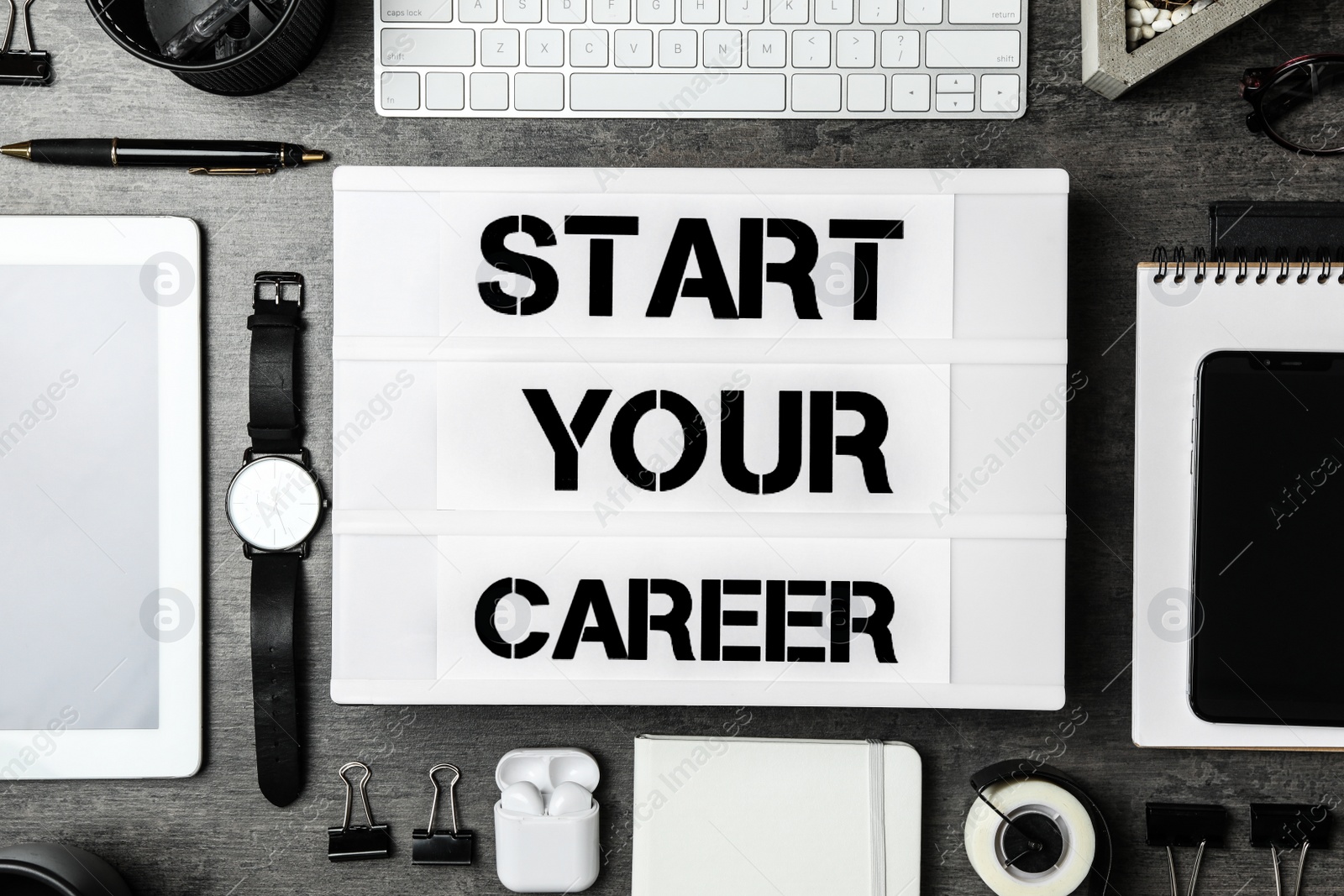 Photo of Flat lay composition with different devices and phrase START YOUR CAREER on grey stone background