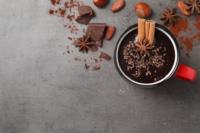 Flat lay composition with yummy hot chocolate on grey table. Space for text