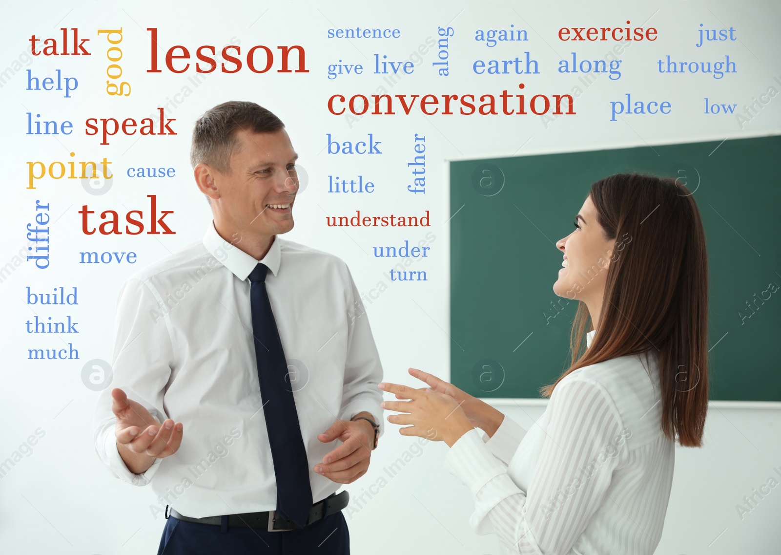 Image of English teacher talking with student surrounded by different words near green chalkboard