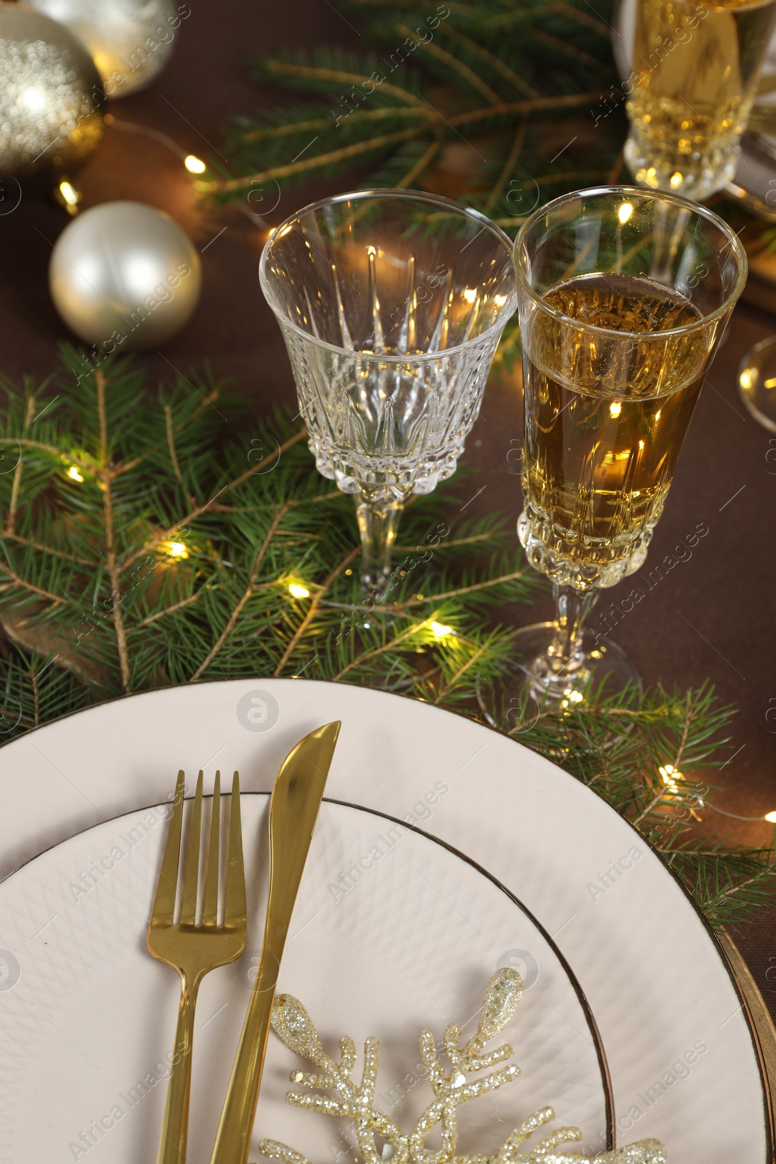 Photo of Table setting with festive lights and Christmas decor