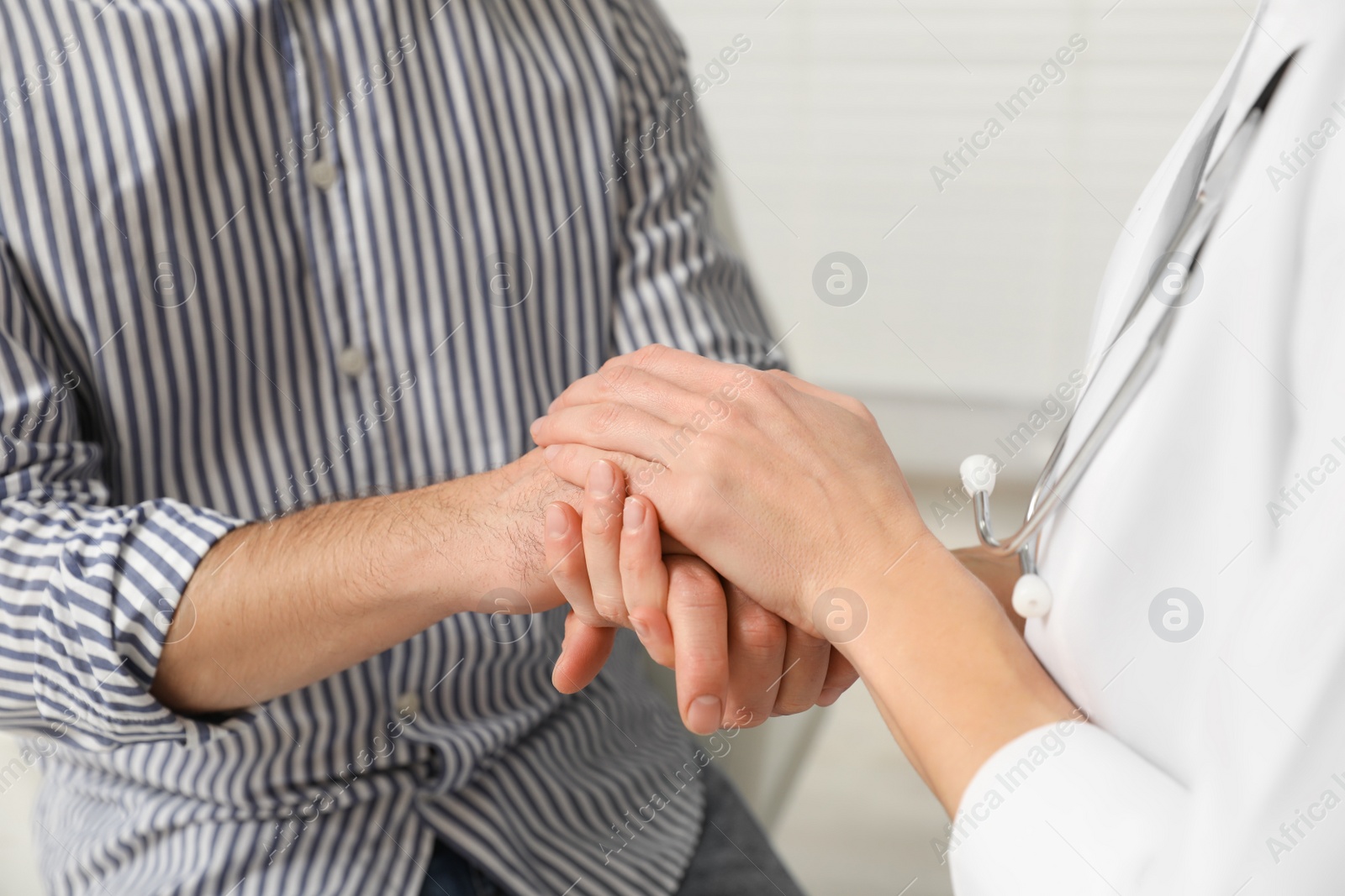 Photo of Patient having appointment with doctor in clinic, closeup