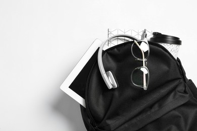 Photo of Stylish urban backpack with different items on white background, top view