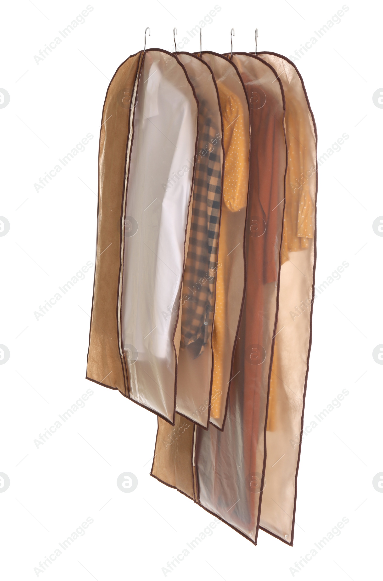 Photo of Garment bags with clothes on white background