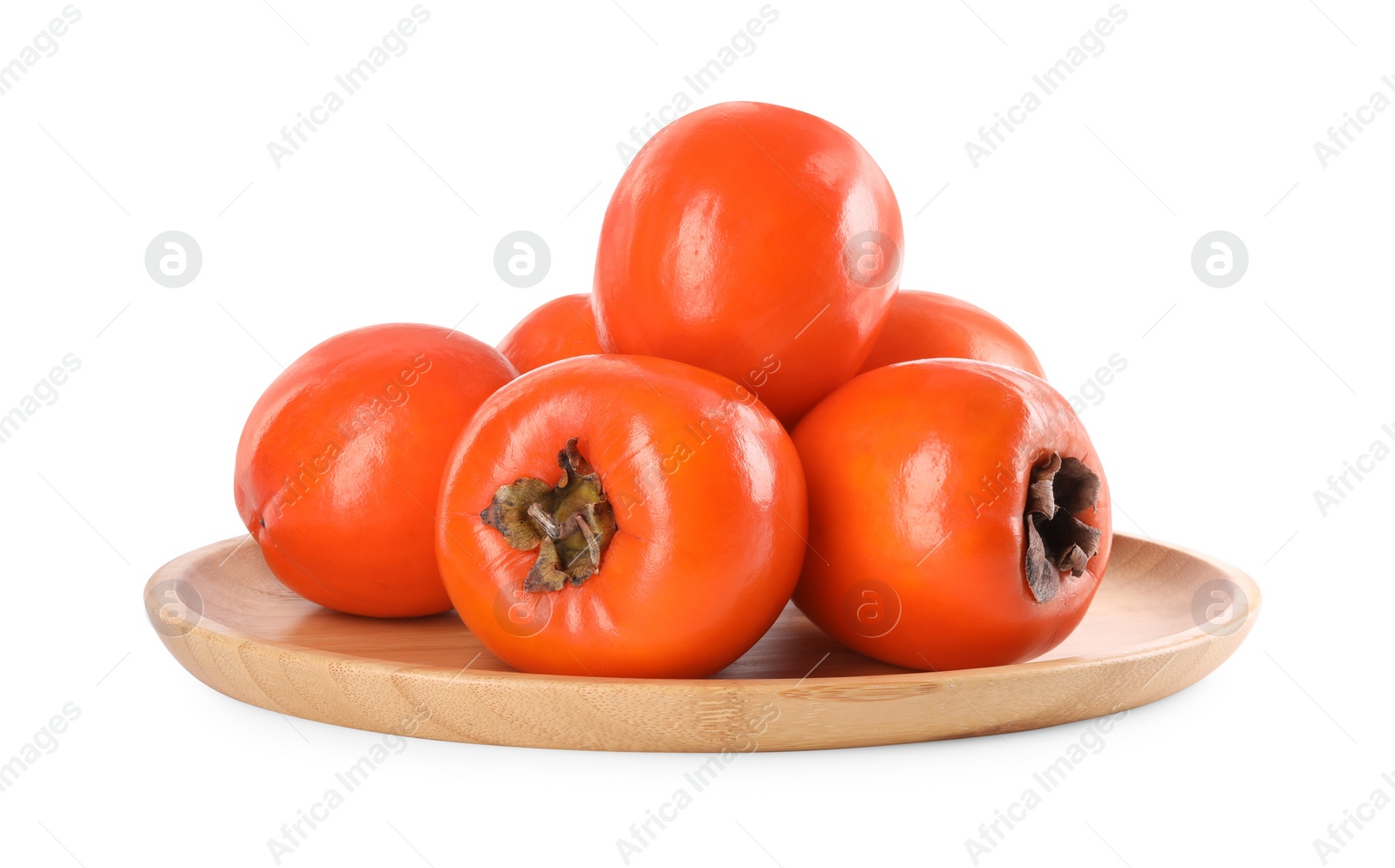 Photo of Delicious ripe juicy persimmons in wooden plate isolated on white