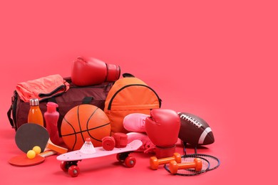 Photo of Many different sports equipment on red background, space for text