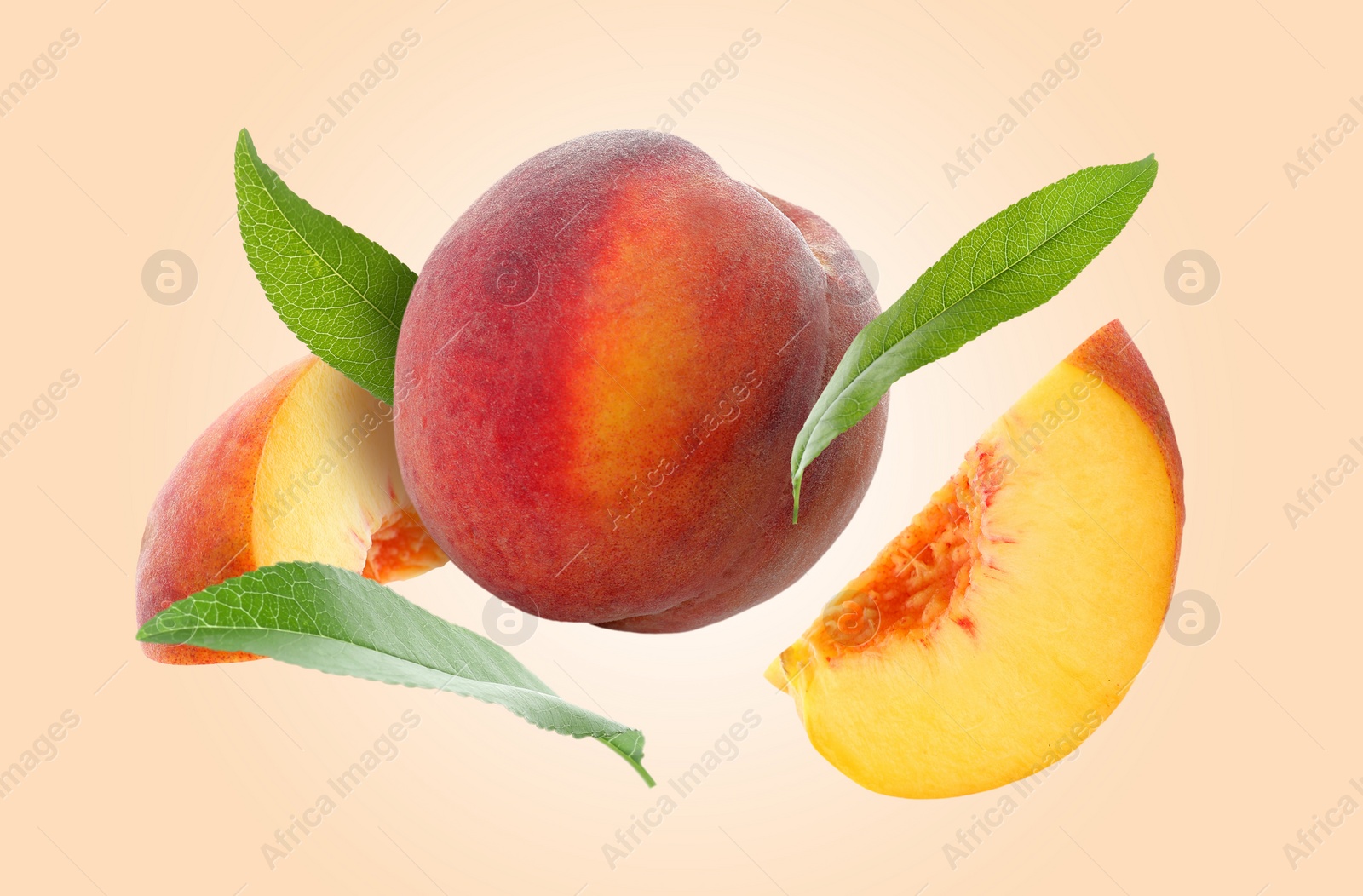 Image of Juicy fresh peaches with green leaves falling on pink beige background