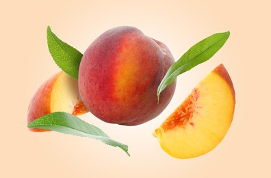 Juicy fresh peaches with green leaves falling on pink beige background