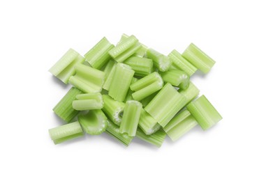 Photo of Heap of fresh cut celery isolated on white, top view