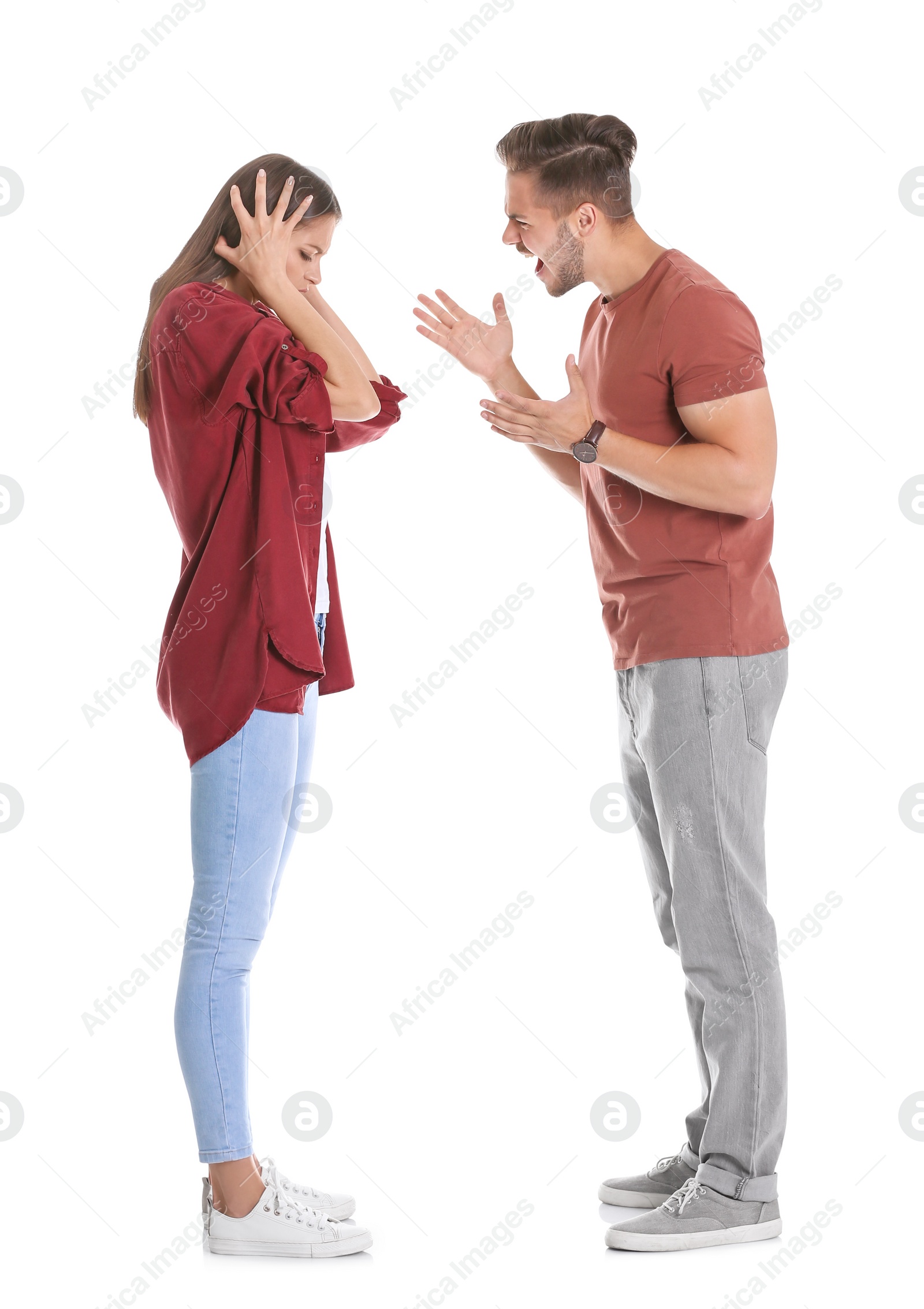 Photo of Young couple having argument on white background. Relationship problems