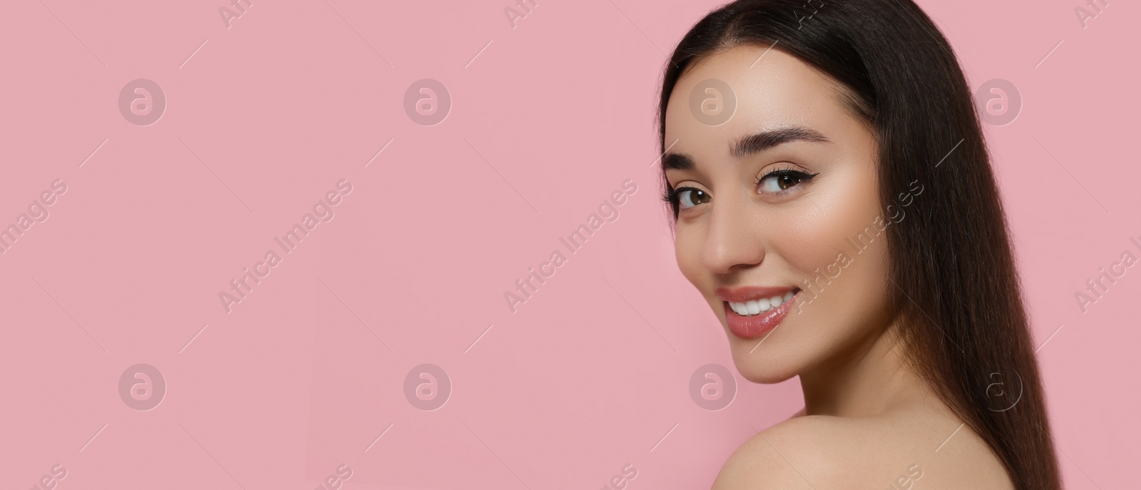 Image of Portrait of beautiful young woman on pink background. Banner design with space for text