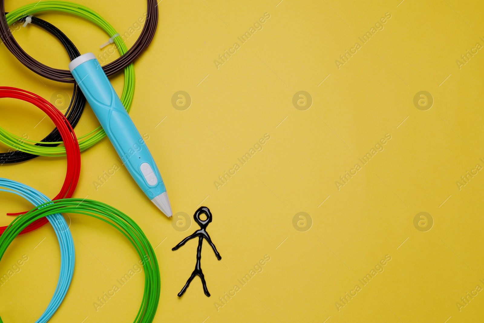 Photo of Stylish 3D pen, colorful plastic filaments and human figure on yellow background, flat lay. Space for text