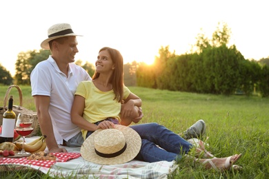 Photo of Happy couple having picnic in park on sunny day