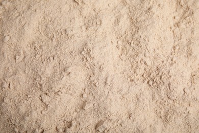 Pile of buckwheat flour as background, top view