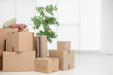 Photo of Pile of moving boxes in empty room