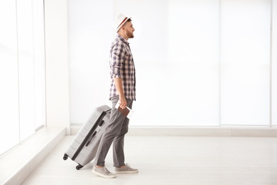 Young man with suitcase in airport