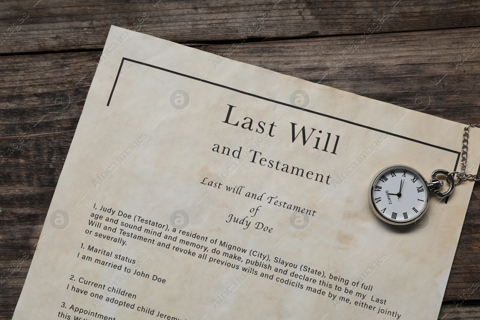 Photo of Last Will and Testament with pocket watch on wooden table, top view