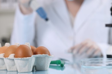 Quality control. Food inspector working in laboratory, focus on eggs
