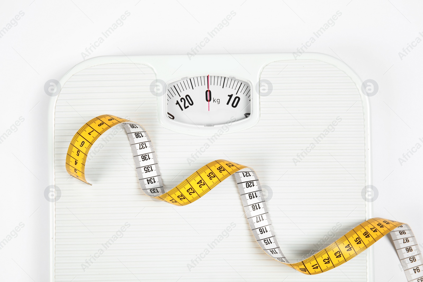 Photo of Modern scales and tape measure isolated on white, top view
