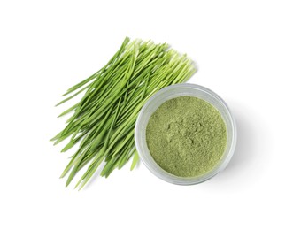 Photo of Wheat grass powder in glass and fresh sprouts isolated on white, top view