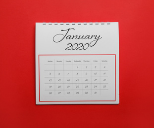 Photo of January 2020 calendar on red background, top view