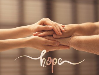 Image of Concept of hope. Caregiver with elderly woman on blurred background, closeup