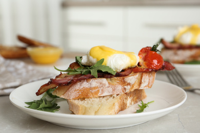 Delicious egg Benedict served on light grey marble table