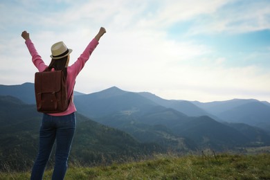 Photo of Woman enjoying mountain landscape, back view. Space for text