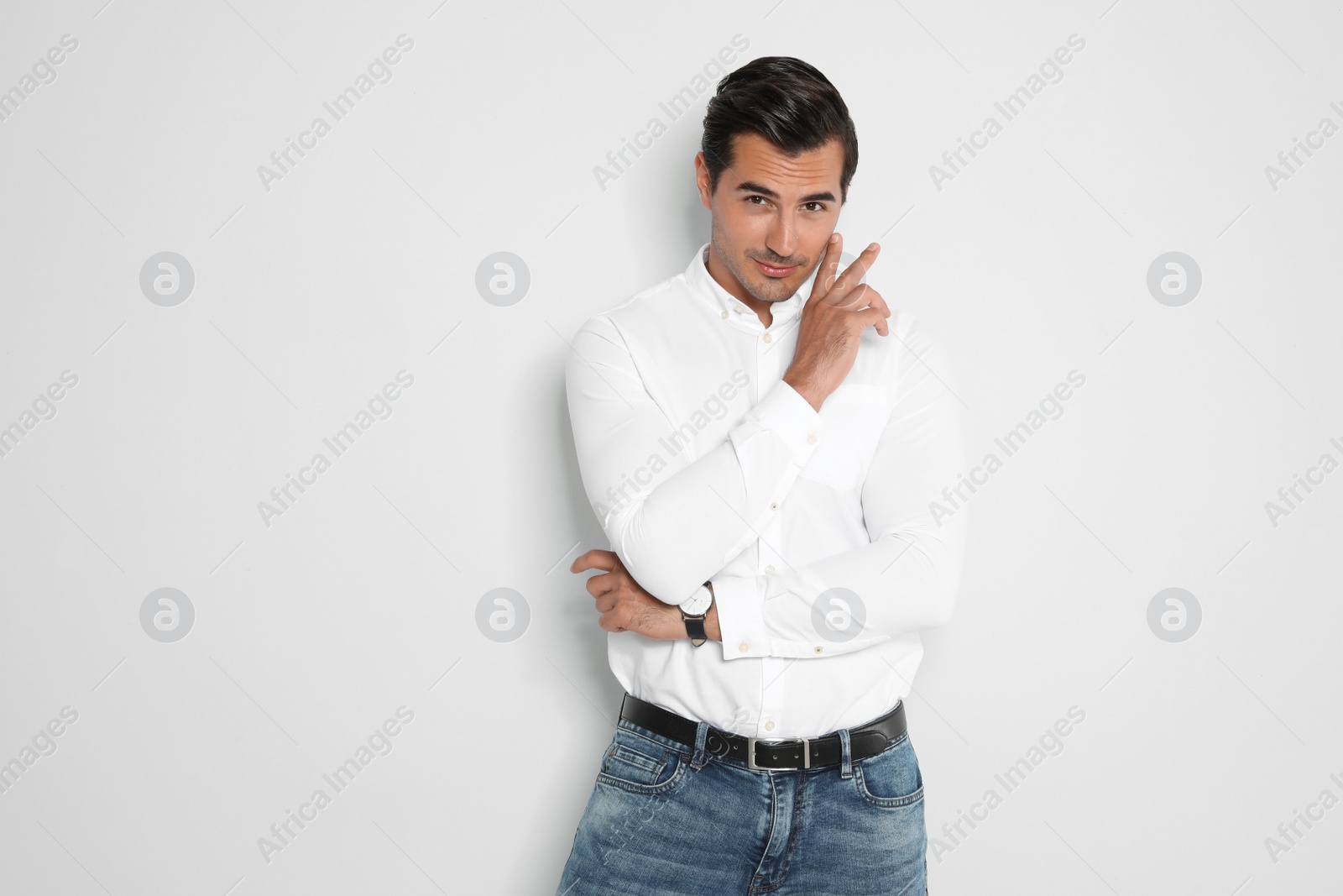 Photo of Portrait of handsome young man on light background