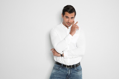 Photo of Portrait of handsome young man on light background