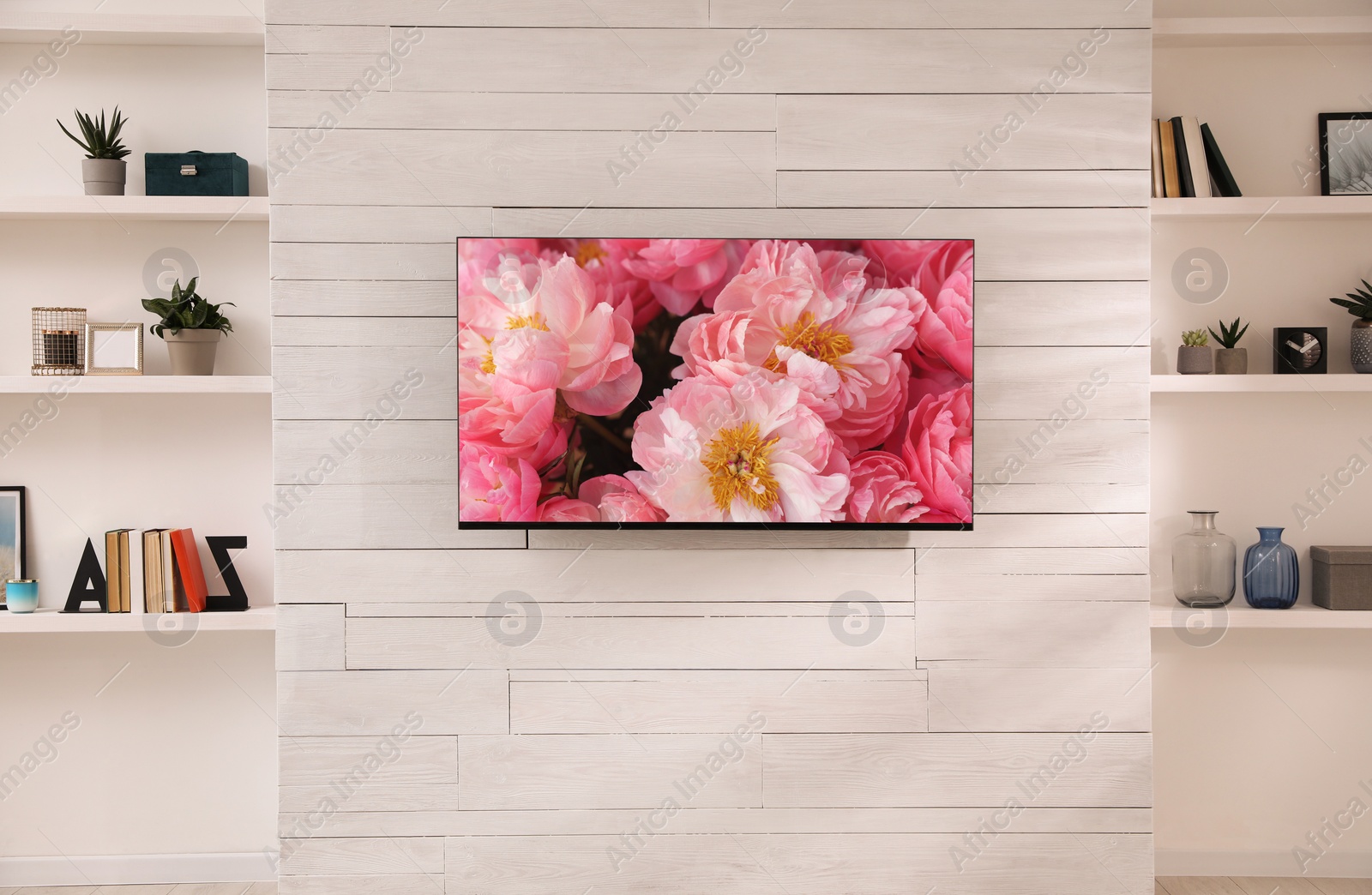 Image of Beautiful peony flowers on TV screen in room