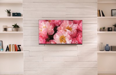 Image of Beautiful peony flowers on TV screen in room
