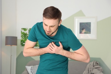 Young man having heart attack at home