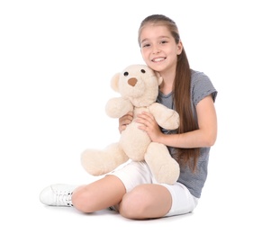 Photo of Playful little child with plush toy on white background. Indoor entertainment