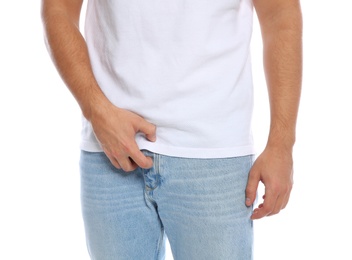 Man scratching crotch on white background, closeup. Annoying itch